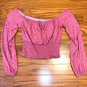 A pink floral,cropped, off the shoulder top